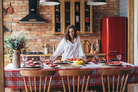 Woman at home in the kitchen at the table with food.