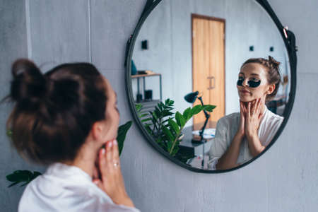 Young woman takes care of her facial skin.の写真素材