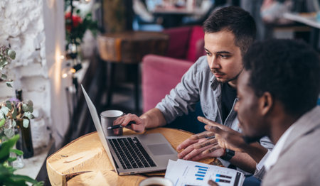 Two business partners working with laptop together.