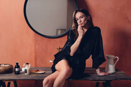 Young woman brushes her teeth before going to sleepの写真素材