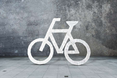White bicycle sign, bike, cycle. Concrete wall backgroundの写真素材