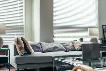 Home interior. Notebook on a coffee table in front of the sofaの写真素材