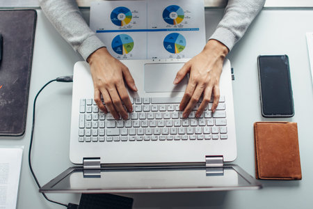 Female hands on laptop keyboard