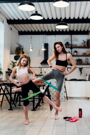 Females working out at home with resistance band.の写真素材
