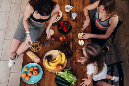Sporty females in the kitchen cooking light foodの写真素材