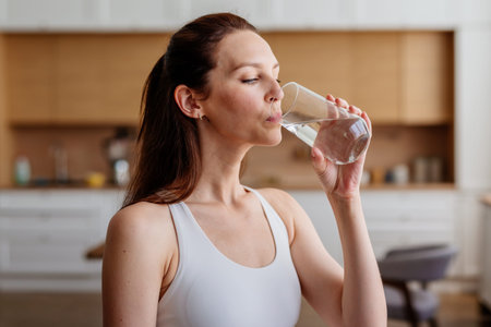 Young woman drinking a glass of water