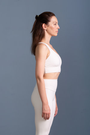 Good posture, a woman stands up straight with correct postureの写真素材