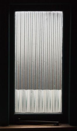 Corrugated iron outside a windowの写真素材