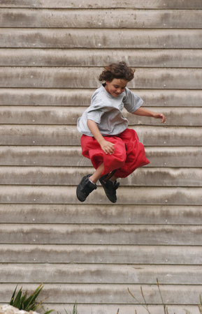 Boy jumps from a farm building
