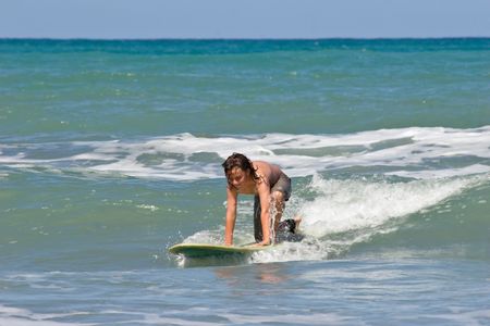 A young caucasian male learns to surf on Whangaehu Beach, Central Hawkes Bay, New Zealand.の写真素材