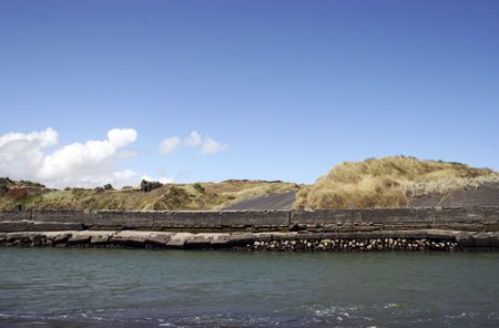 Sea wall at the river mouth at Patea, Taranaki, New Zealandの写真素材
