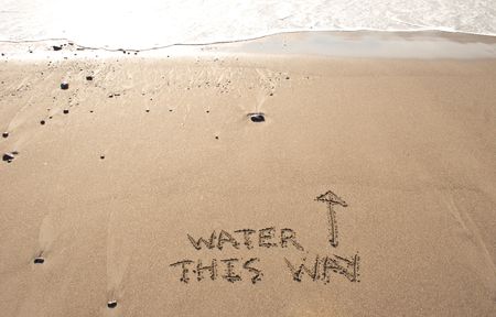 Water this way written in the sand at Haumoana Beach, Hawke's Bay, New Zealandの写真素材