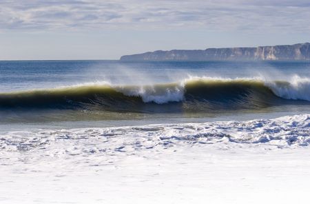 Waves breaking with Cape Kidanppers in Background. Hawke's Bay, New Zealandの写真素材