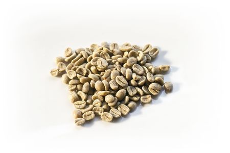 A pile of unroasted green beans on a white backgroundの写真素材