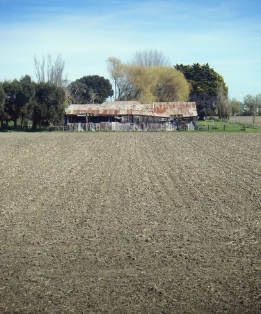 A corrugated iron shed sits on the edge of a ploughed field in Clive, Hawkes Bay', New Zealandの写真素材