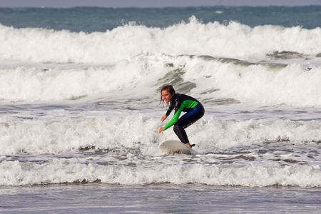 A young male learning to surf at Waimarama Beach, Hawkes Bay, New Zealandの写真素材