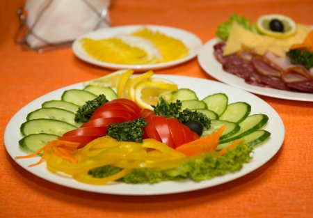 Vegetable assortment on a dish on a orange backgroundの写真素材