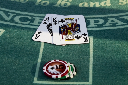 Close up on a players Blackjack hand  The player has a King and Ace of Spades with a bet of  30 in chips の写真素材