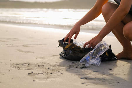 people keeping garbage of plastic bottle on the beachの写真素材
