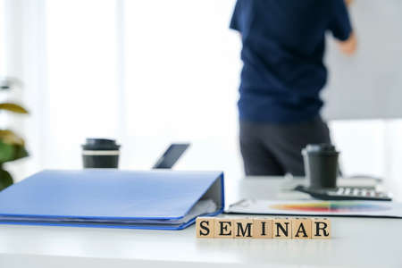 Text wooden cubes spelling is seminar on table meeting roomの写真素材