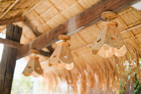 closeup lamps made of wood hang under roof thatch, Select focusの写真素材