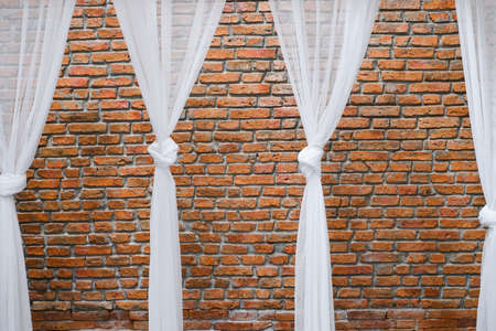 white color curtain and brick wall backgroundの写真素材