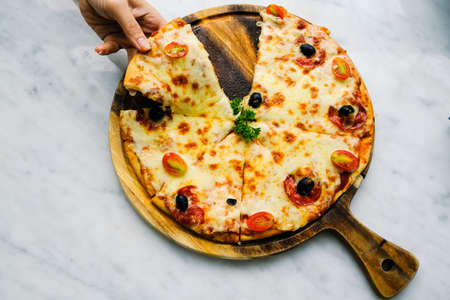 Pizza pepperoni on wooden trayの写真素材