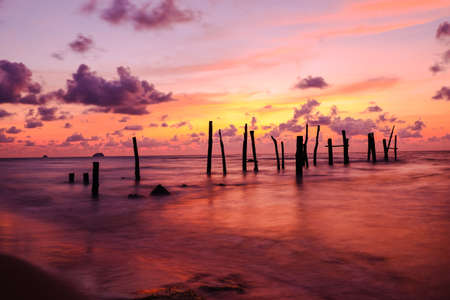 Old wooden bridge abandoned pier stumps at Thungsang bay in Chomphon province Thailand, Tropical beach seaside, White Balance effectの写真素材