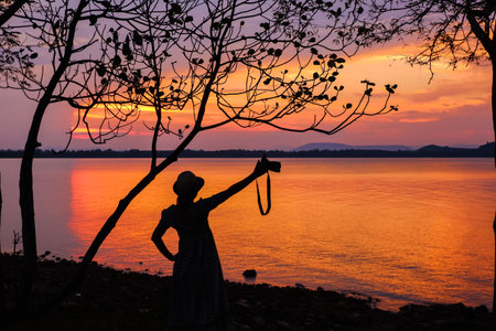 tropical beach seaside on sunset time at Laem Hua Mong - Kho Kwang Viewpoint in Chomphon province Thailand with silhouette girl photographyの写真素材