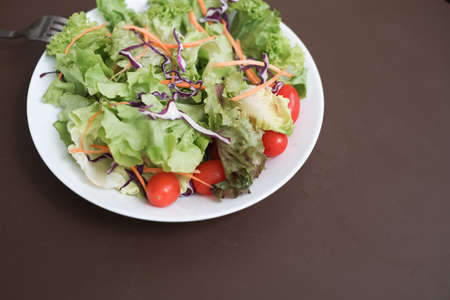 mixed vegetable salad organic on the white dishの写真素材