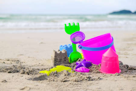 kids beach bucket toys or sand box on tropical sand beachの写真素材