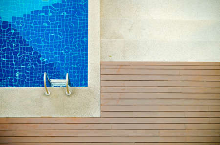 Swimming pool and wooden floor top viewの写真素材