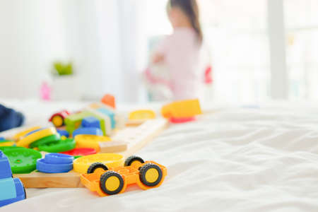 colorful plastic toys with blurred child in the backgroundの写真素材