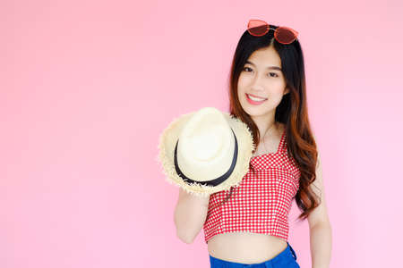 Portrait beautiful asian girl beaming smile with fashion eyewear on pink background, emotions action, happy summer life conceptの写真素材