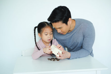 single father teaching daughter to saving money