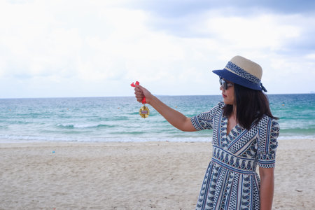 Woman holding medal winner in hand on sea backgroundの写真素材