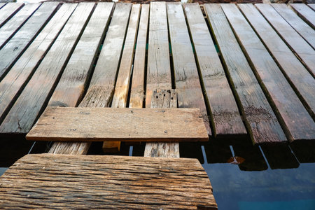 plank of wooden bridge floating water