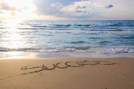 hand write success message on the sand beachの写真素材