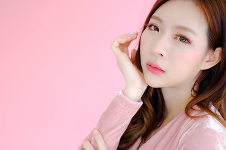 posing beautiful asia woman on pink background, emotions action, fashion set