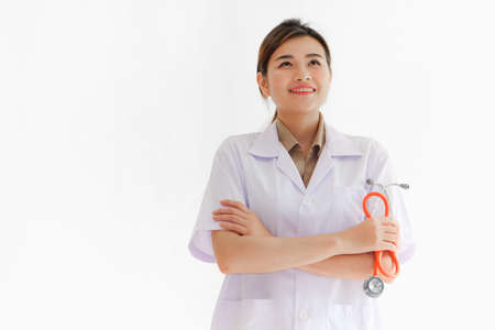 Asian doctor woman dressed in white gown with stethoscopeの写真素材