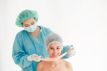 The doctor is examining woman undergo surgeryの写真素材