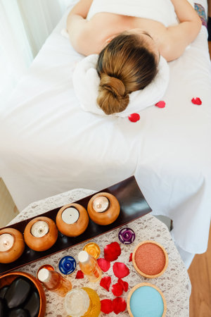 asian woman relaxing in spa salon lying on the bed