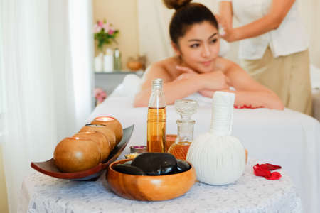 Young asian woman relaxing in spa massage lie on your stomach on the bedの写真素材