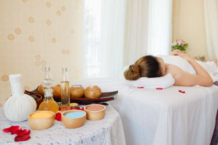 asian woman relaxing in spa salon lying on the bedの写真素材