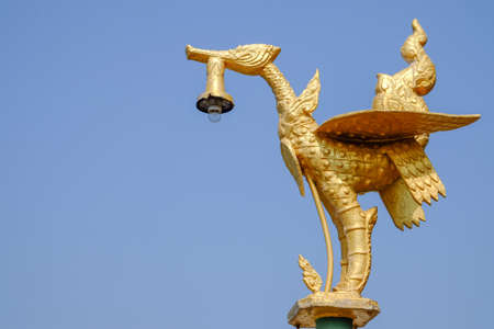 Golden swan lamp with skyの写真素材