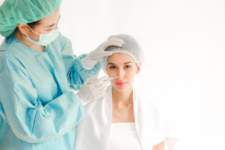 The doctor is examining woman undergo surgery, beauty conceptの写真素材