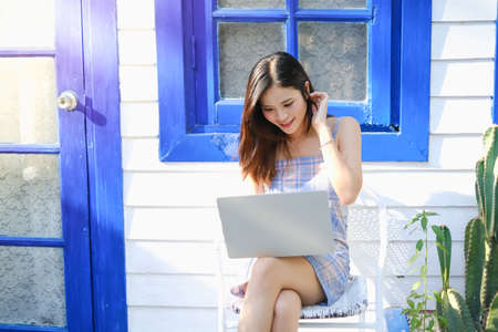 Asian woman playing or working with laptopの写真素材