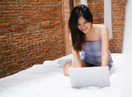 Asian woman playing or working with laptopの写真素材