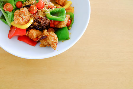 fried fish topped with sweet sauce on rice on table