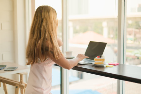 adult caucasian woman playing tablet in morning